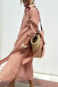 Detailed view of the orange geometric pattern on a stylish collared shirt dress
