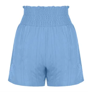 Detailed view of light blue smocked high waist sports shorts with textured fabric