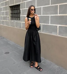 Elegant vintage Hepburn style black sleeveless midi dress worn in a street setting