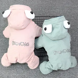 Close-up of padded pet winter coats featuring cartoon eyes and cozy hooded design