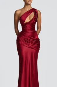 Close-up detail of red satin one-shoulder pleated mermaid dress with stylish cutout design