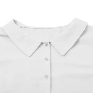 Close-up detail of the classic collar and buttons on a white cotton-linen casual dress