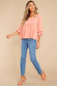 Elegant peach square neck blouse featuring ruffled puff sleeves and empire waist