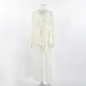 Detailed macro view of cream-white ruffled wrap top and wide-leg trousers tencel set for women