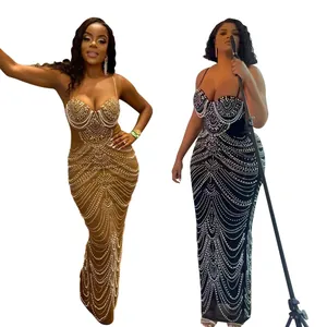 Detailed view of elegant spaghetti strap evening dresses with rhinestones and beads.