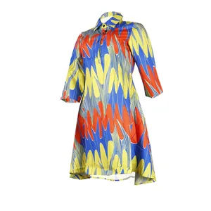 Detail view of a slim-fit lapel collar dress with vibrant multicolor flame print pattern.