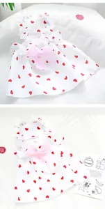 Detailed close-up of white pet summer strap dress with red heart prints and pink bow