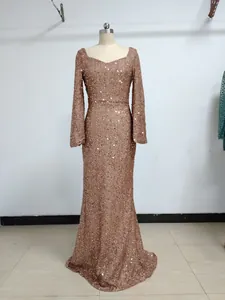 Full view of a rose gold sequined V-neck evening gown displayed on a tailor mannequin