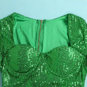 Close-up of green sequin dress with gold zipper detail and sweetheart neckline