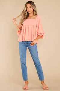 Stylish coral square neck blouse with tiered puff sleeves on a blonde model