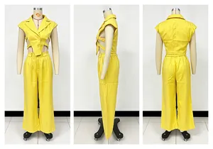 Detailed view of yellow two-piece set featuring cutout waist and wide-leg trousers.