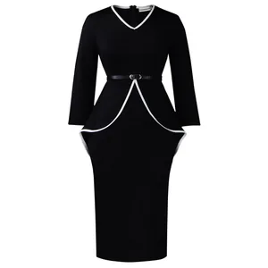 Detailed view of the black peplum dress with elegant white piping and a V-neckline.