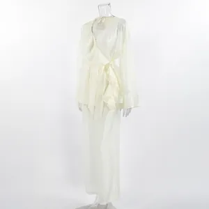 Detailed view of cream Tencel ruffle wrap top and wide-leg pants set on mannequin