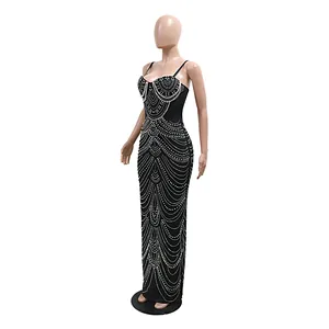 Detailed view of elegant black maxi evening dress with intricate white pearl patterns