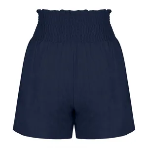 Front view of navy blue high-waisted smocked shorts with subtle vertical texture