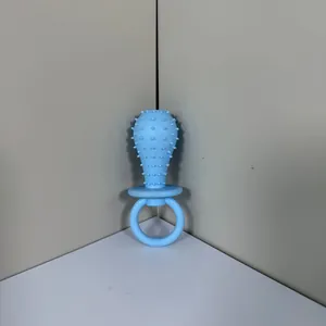 Close-up of blue spiked TPR pet pacifier chew toy showing textured surface for teething
