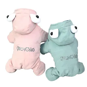 Close-up detail of two cute padded pet winter coats with funny big eye hood decorations