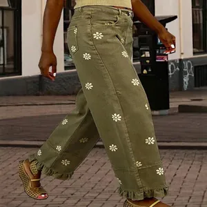 Retro olive green wide-leg jeans with white daisy print and ruffled hems