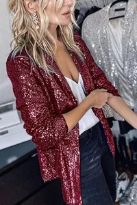 Close-up detail of a women's wine red sequin blazer jacket worn over a white top
