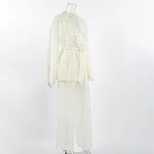 Elegant cream Tencel two-piece set featuring a ruffled wrap top and wide-leg pants detail