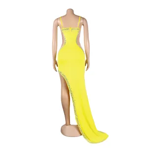 Rear view of yellow evening dress featuring sheer panels and rhinestone accents