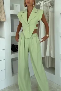 Chic lime green two-piece set featuring a sleeveless cutout vest and wide-leg trousers.