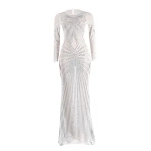 Detail view of shimmering rhinestone patterns on white floor-length evening dress