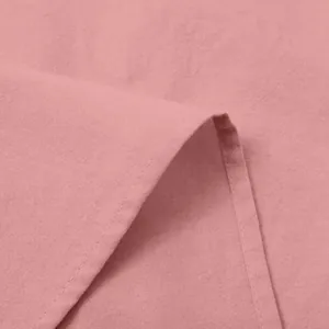 Close-up detail of pink cotton linen fabric texture for women's casual dress