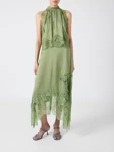 Detail view of an olive green two-piece set featuring lace trim and a slit skirt