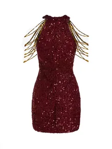Close-up of elegant burgundy sequin halter dress featuring gold chain fringe detail