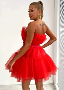 Detail of a red strapless tulle dress with ruffled bodice and puffy layered skirt