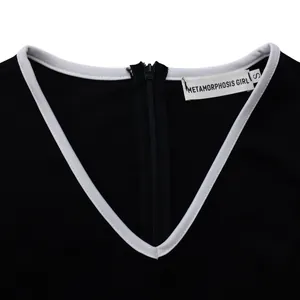 Close-up of V-neckline with white piping and back zipper on a black pencil dress