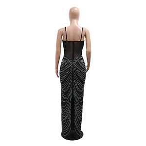 Detailed back view of a black evening gown with rhinestone patterns and mesh panel