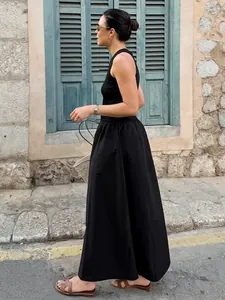 Elegant vintage Hepburn style black sleeveless knit maxi dress with a slim waist silhouette