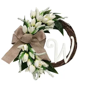 Artificial white tulip wreath with burlap bow and decorative white letter W monogram