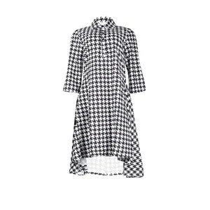 Detailed view of houndstooth dress featuring high-low hem and classic lapel collar