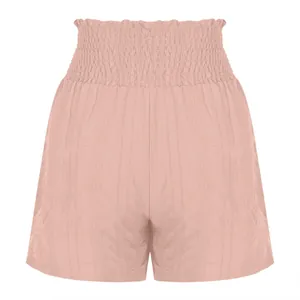 Close-up of stylish pink high-waisted smocked shorts with unique textured fabric detail