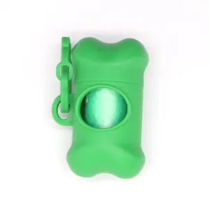 Detailed view of a green bone-shaped dog poop bag dispenser with a roll inside
