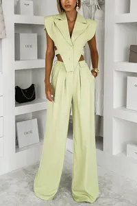 Model wearing light green sleeveless blazer vest and high-waisted wide-leg pants set