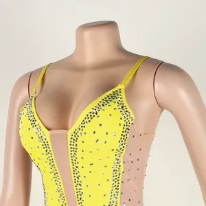 Detailed view of yellow camisole dress with sparkling rhinestones and mesh panels