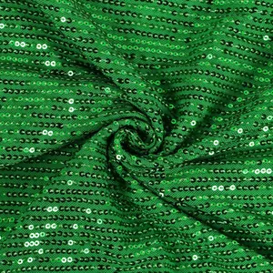 Macro view of vibrant green sequined fabric showing detailed texture and shiny sparkle