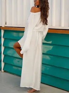 Elegant white two-piece skirt set with loose long-sleeved top and high slit skirt