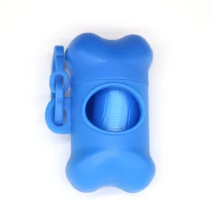 Detail view of a bright blue bone-shaped dog waste bag dispenser for outdoor use