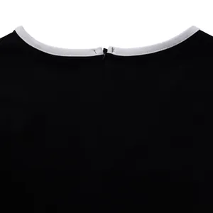 Close-up view of elegant black dress neckline with contrast white trim and back zipper