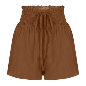 Close-up of high-waisted drawstring shorts in a solid caramel brown texture.