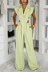 Detail view of the lime green sleeveless cropped vest and high-waist wide-leg trousers set