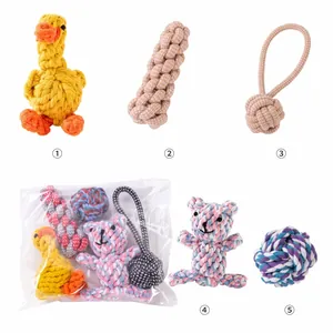 Close-up view of various handmade cotton rope dog toys including duck and bear shapes