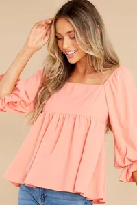 Detail view of a peach square neck blouse with mid-length puff sleeves for women.