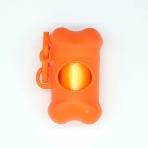 Bone-shaped orange dog poop bag dispenser for outdoor pet waste cleanup.