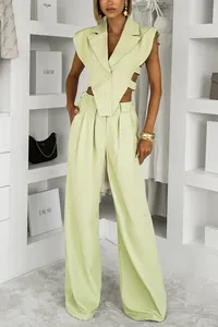 Detail view of stylish light green two-piece set with sleeveless vest and wide-leg pants.